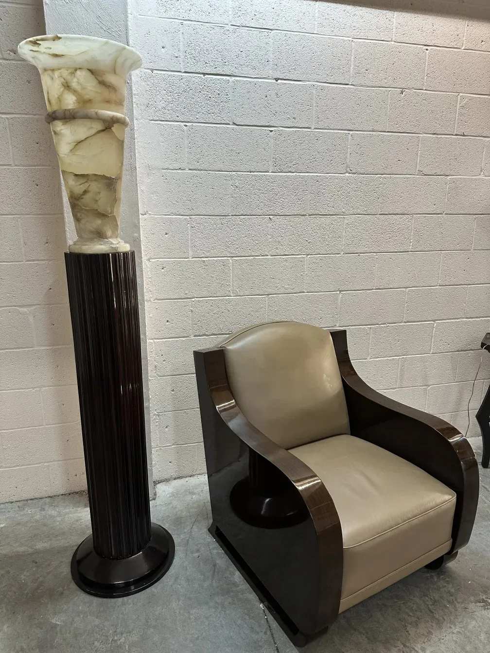 Two antique armchairs with light upholstery in a modern setting.