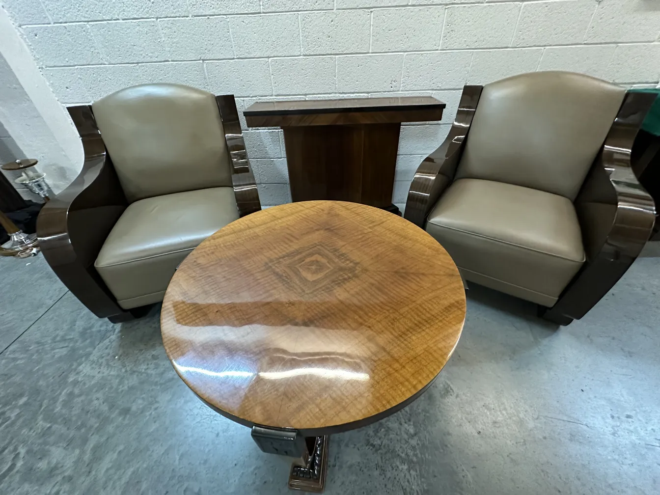 antique coffee table in an elegant setting, with chairs beside