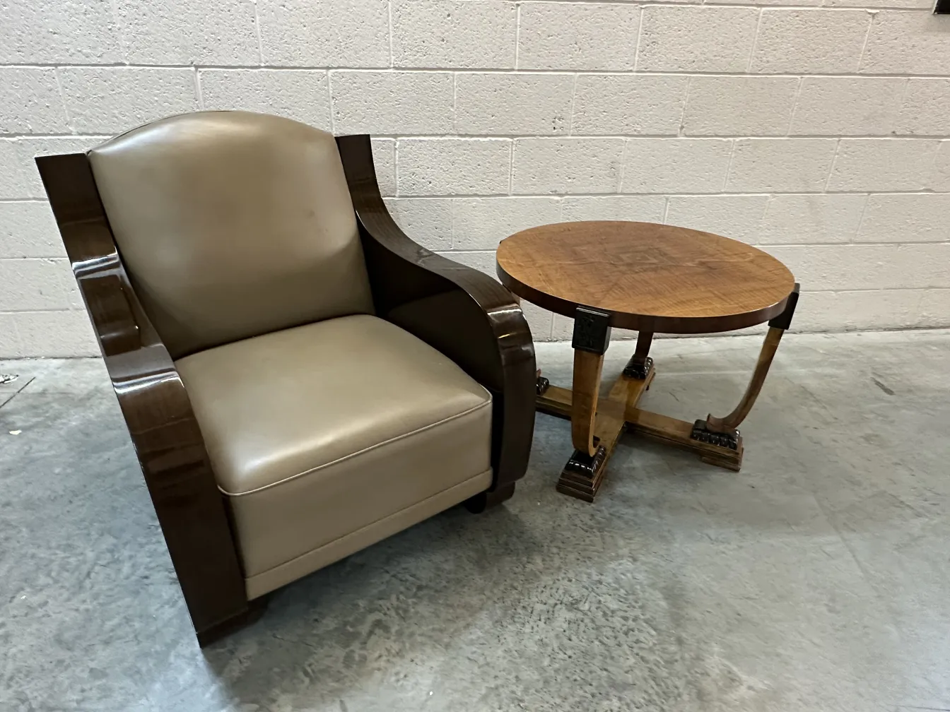 Antique coffee table with round top and decorative legs, set in a cozy environment.