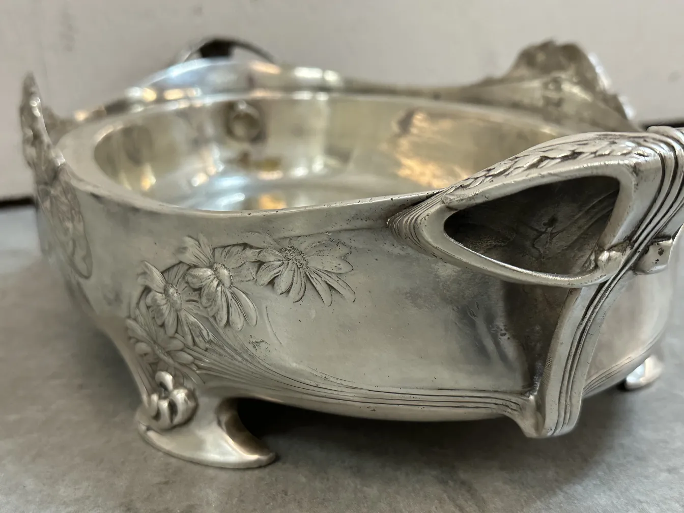 antique centerpiece with floral details and decorative feet