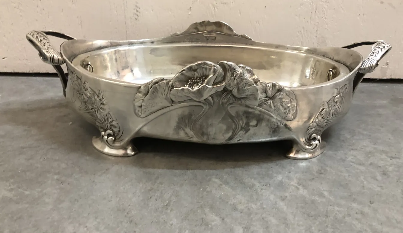 antique centerpiece decorated with floral patterns and ornate legs in a classy setting.