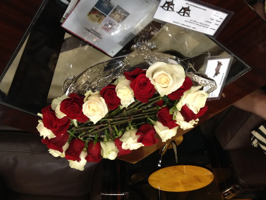 antique centerpiece with red and white roses on table