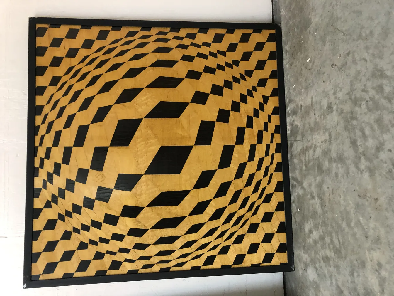 Antique marquetry with decorative patterns in yellow and black.