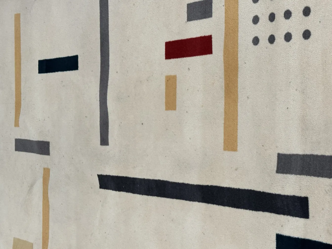 antique carpet with light background and geometric patterns