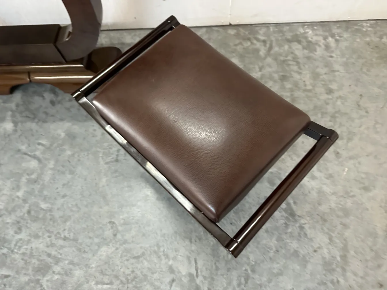 antique stool with simple structure and brown seat