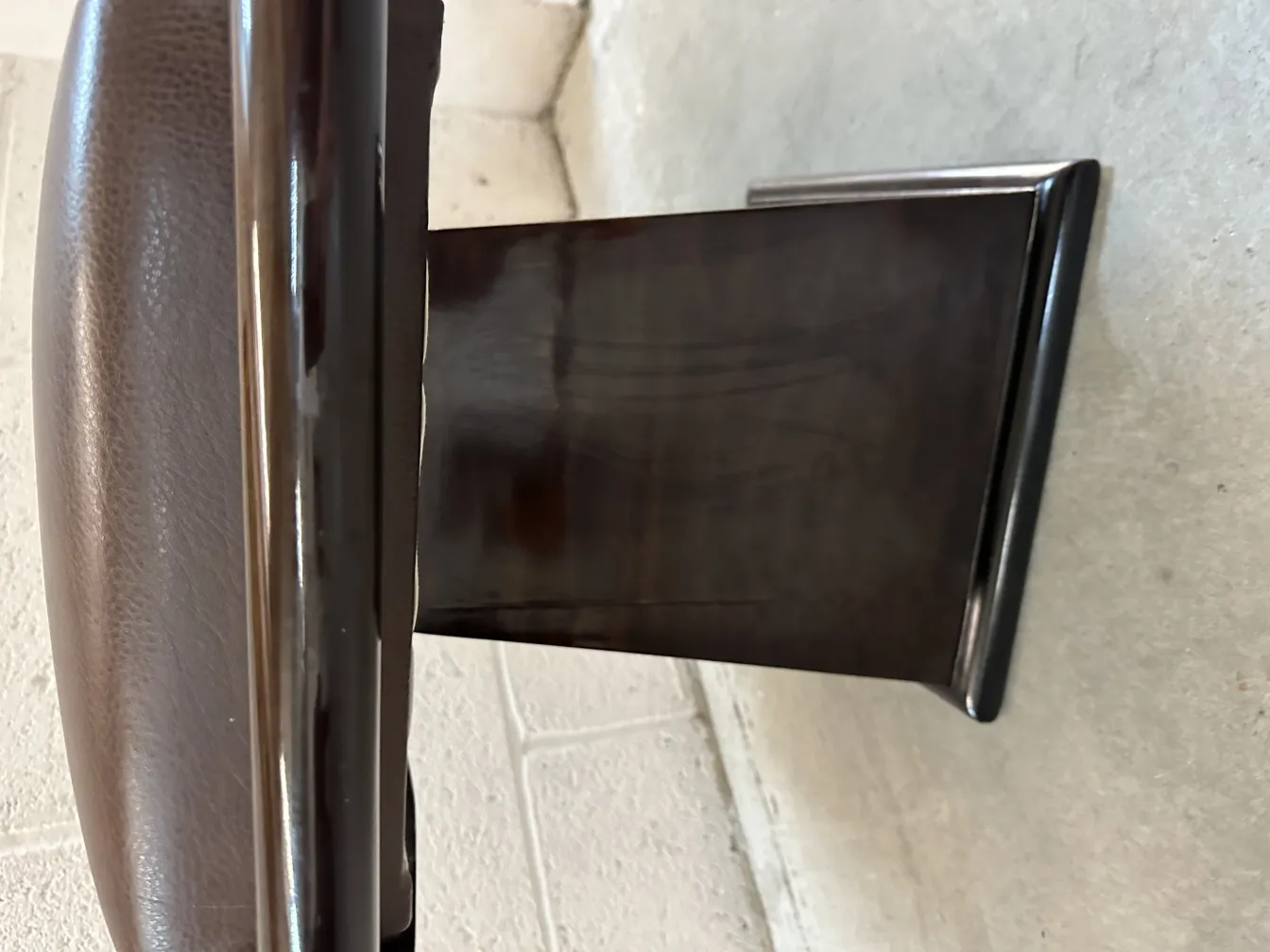 side view of an elegant antique sidewalk stool, neutral background