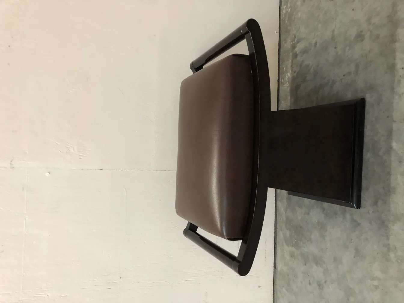 antique sidewalk chair with stylish arms, neutral background.