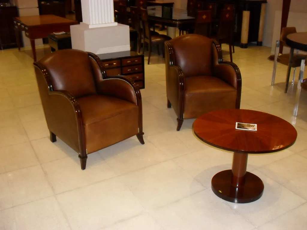Antique small table with round design in room with chairs