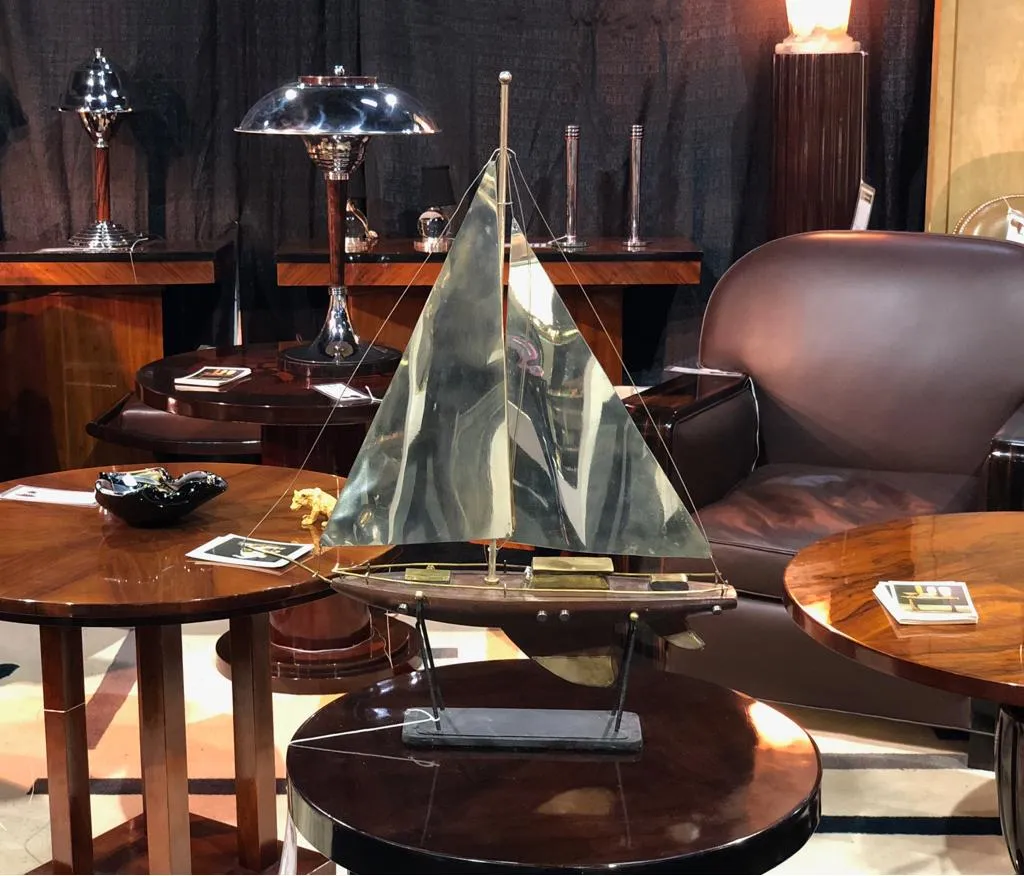 古董小桌子有装饰帆船和背景中的灯具。