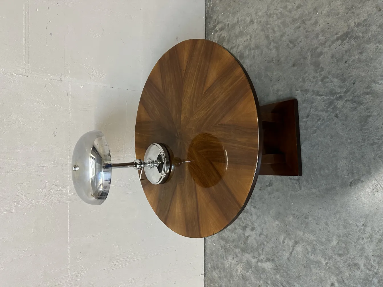 antique round small table beside a modern lamp