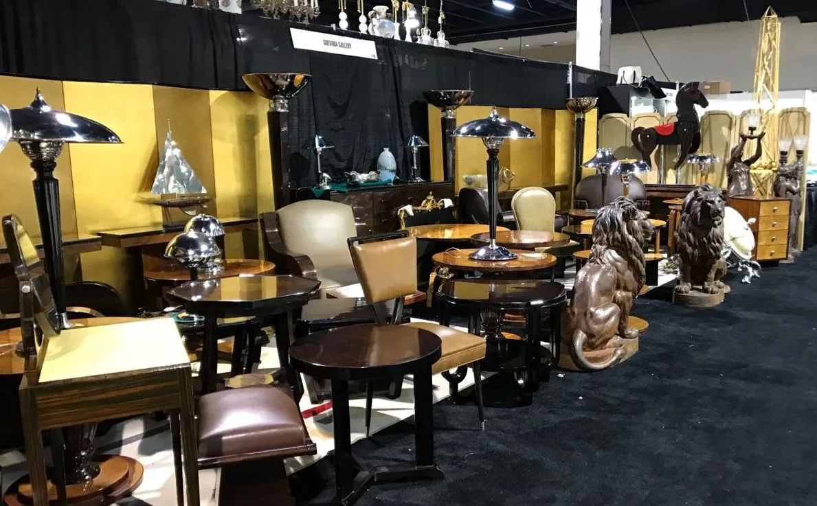 Antique small table with elegant design, surrounded by other furniture.