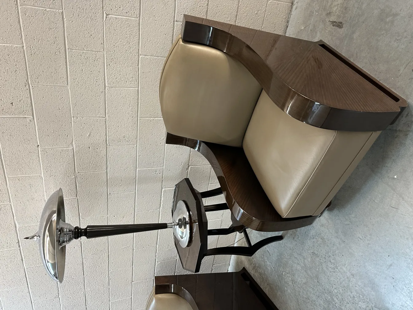 antique small table with curved shape and lamp next to it