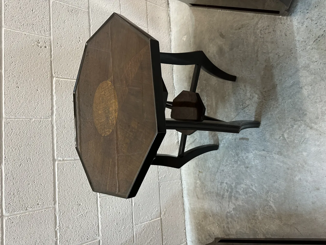 antique small table octagonal with details in a simple setting