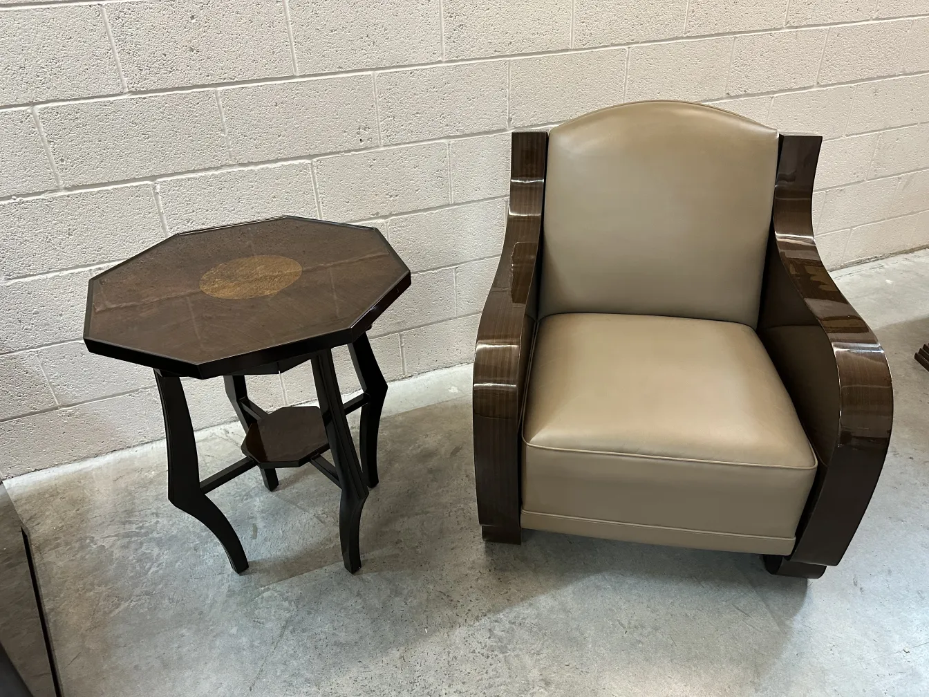 antique small octagonal table with central decoration, next to an armchair