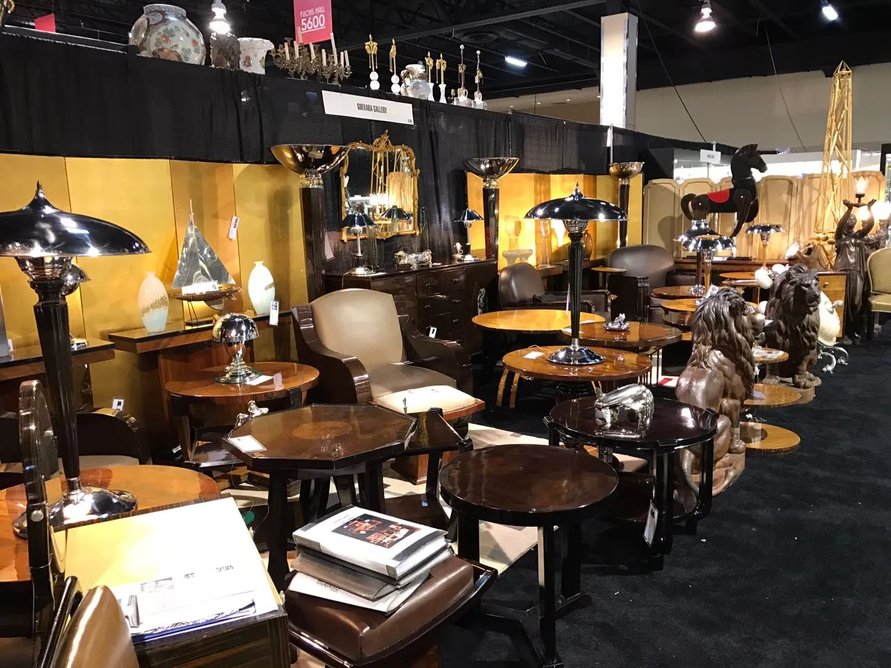 round antique small table in elegant room with lamps and decor