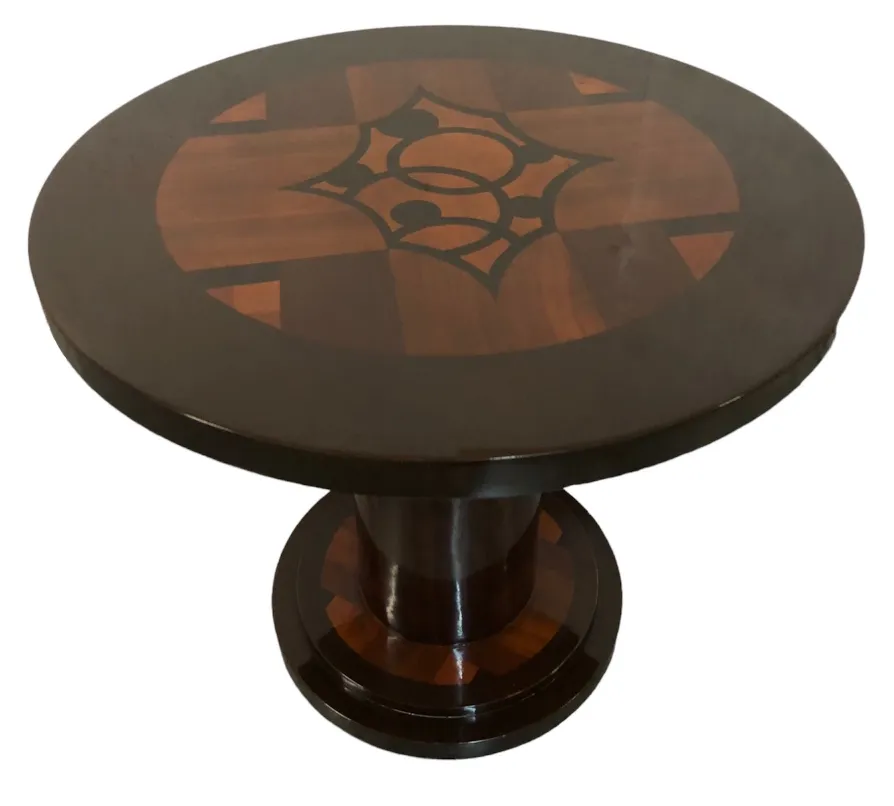Antique round small table with decorative design on top, elegant and classic
