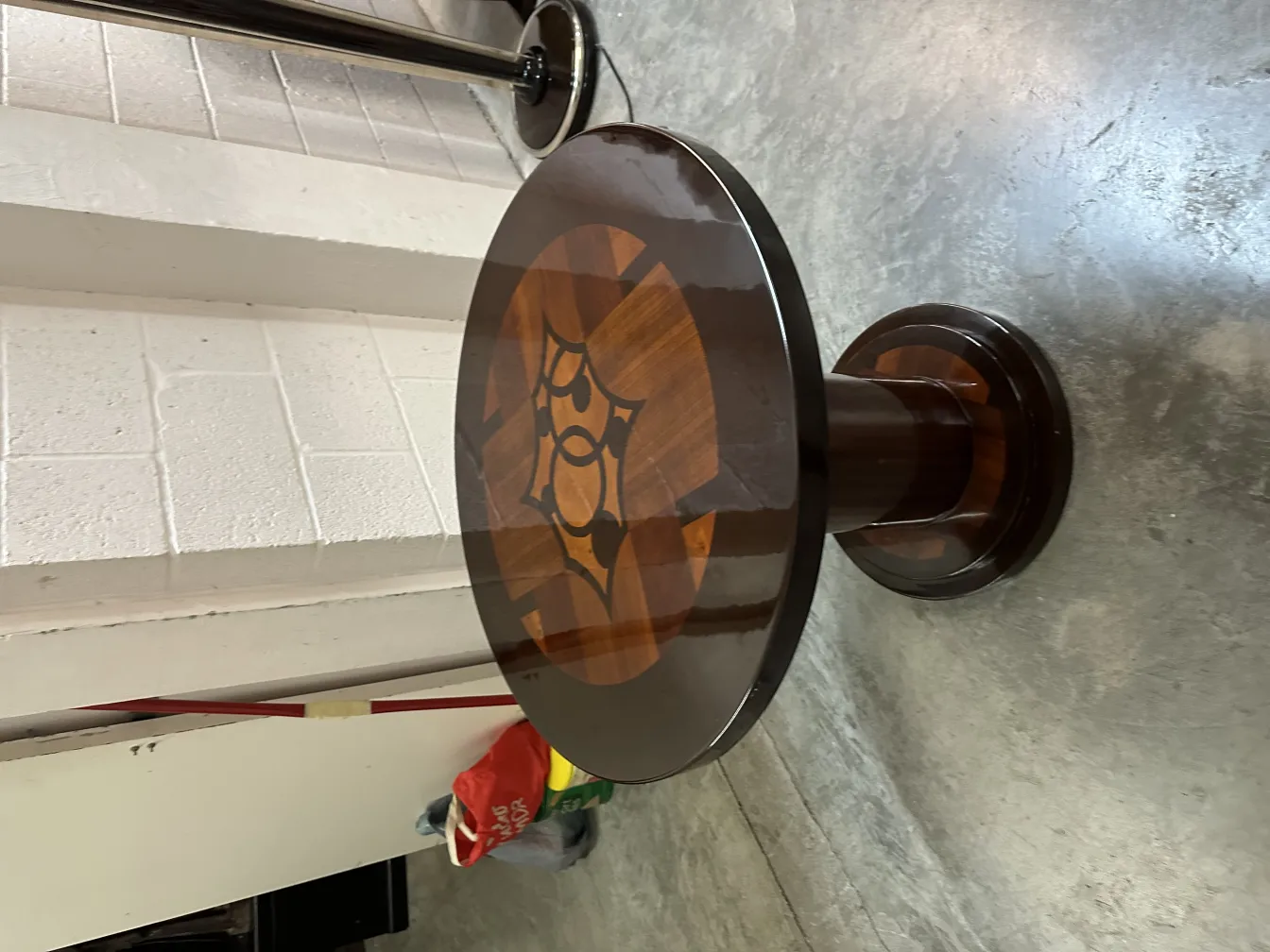 Round antique small table with artistic drawing on the surface, simple and modern environment