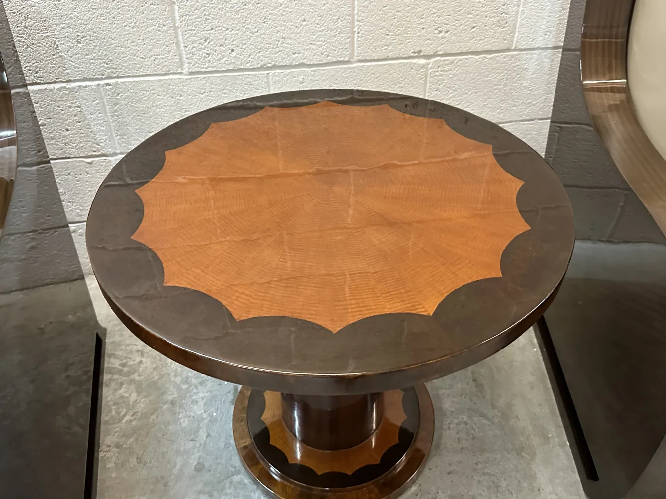 round antique table with decorative details and pedestal