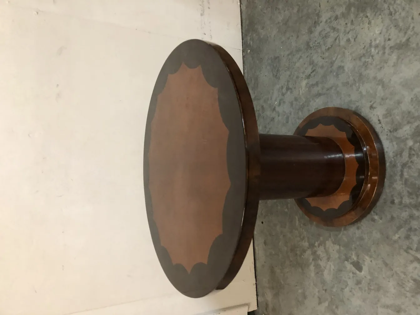 antique round small table with detailed edge and elegant base