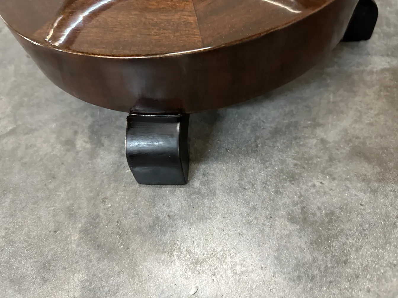 Tavolino antico con gambe curve in un ambiente semplice.