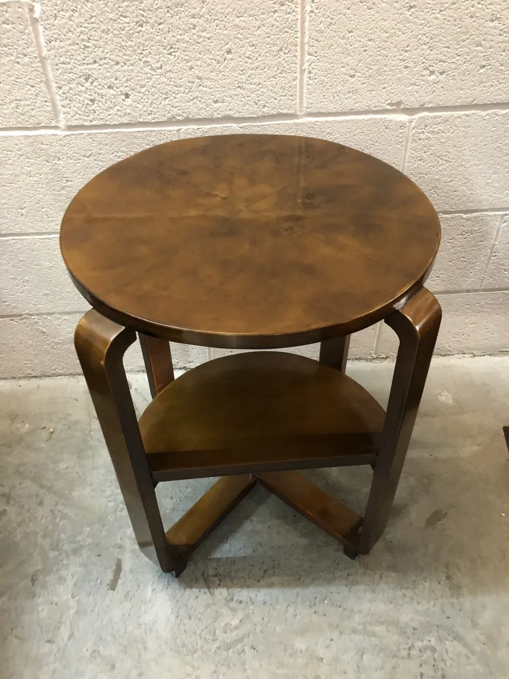 Antique round small table with brown finish, simple setting.