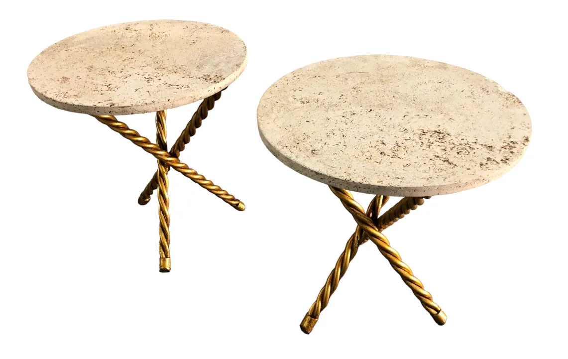 Front view of two antique round small tables with golden legs.
