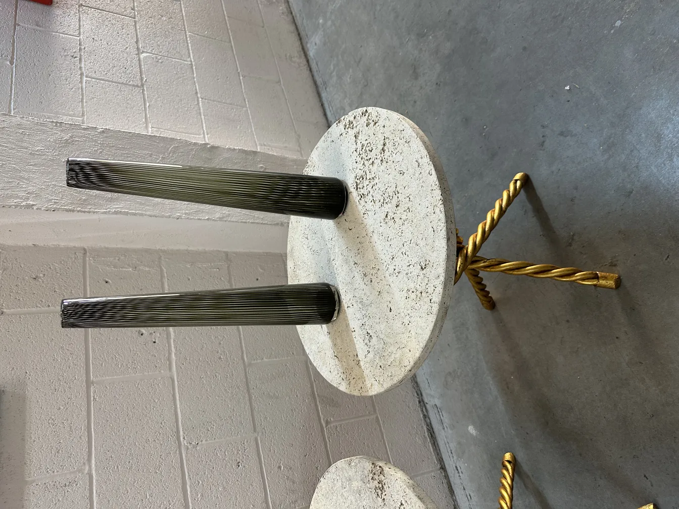 Two antique small tables with decorative design in a light setting
