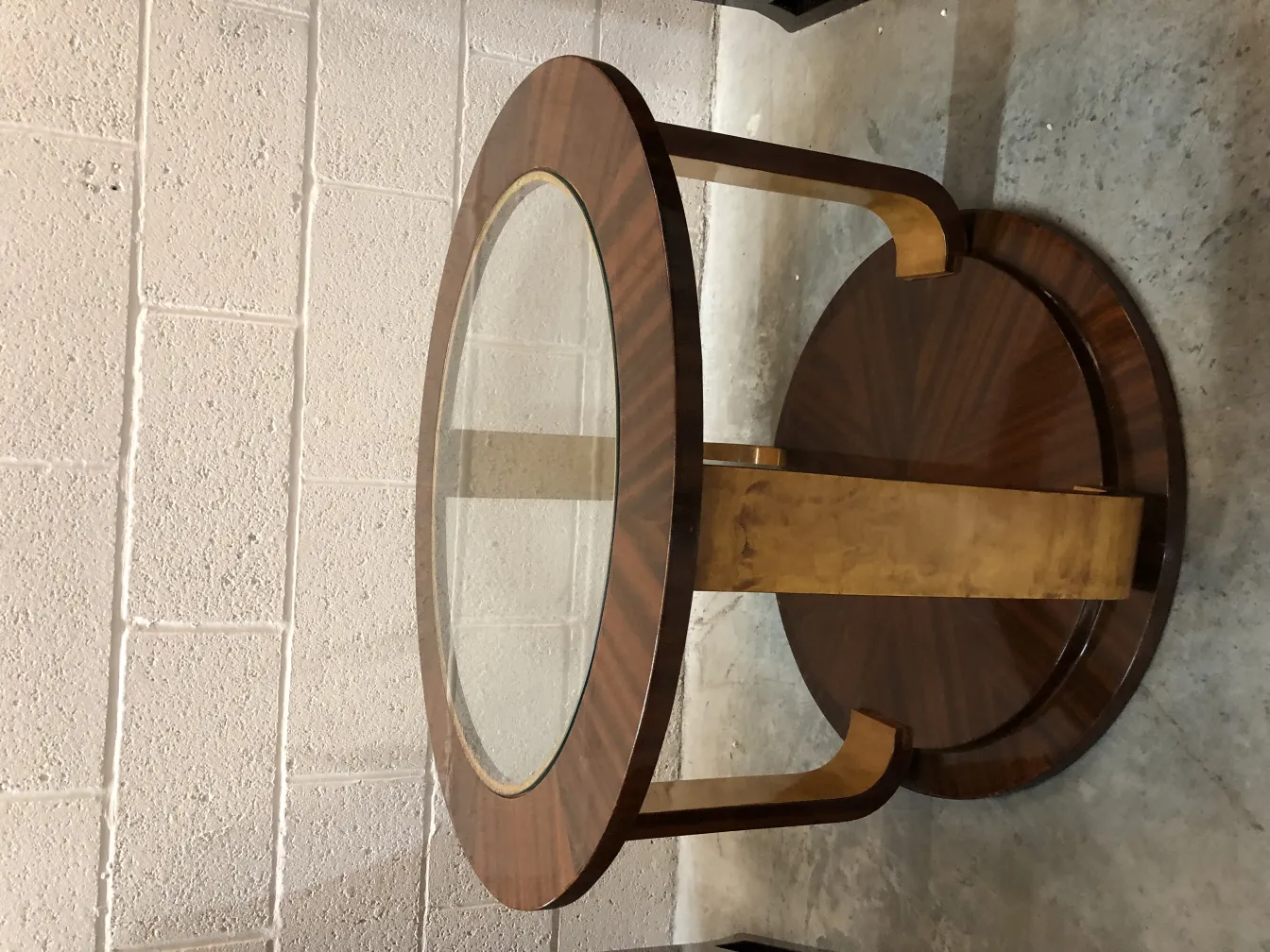 Two antique small tables with an elegant design and glass top, set in a modern decor.