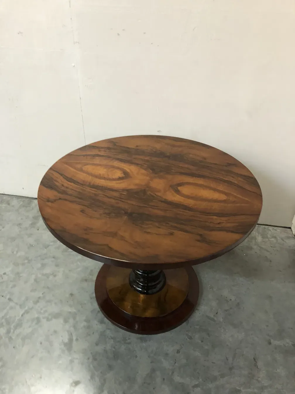 Conjunto de 2 mesinhas antigas com tampo oval e base robusta, fundo simples.