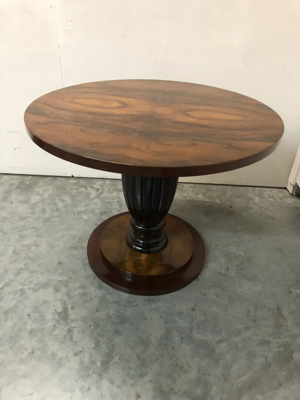 Two antique tables with an elegant design in a classic setting.