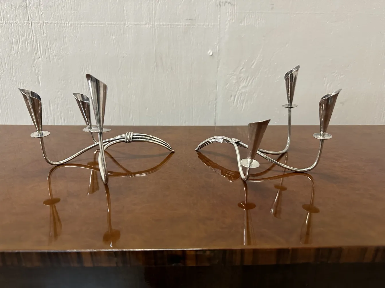 two antique candelabras with elegant design on a table