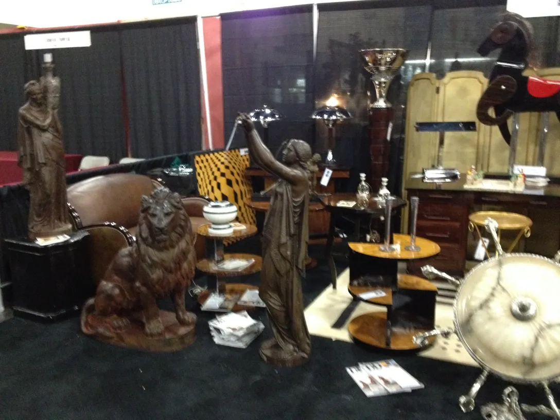 Two antique decorative candelabras on a dark surface, elegant and detailed.