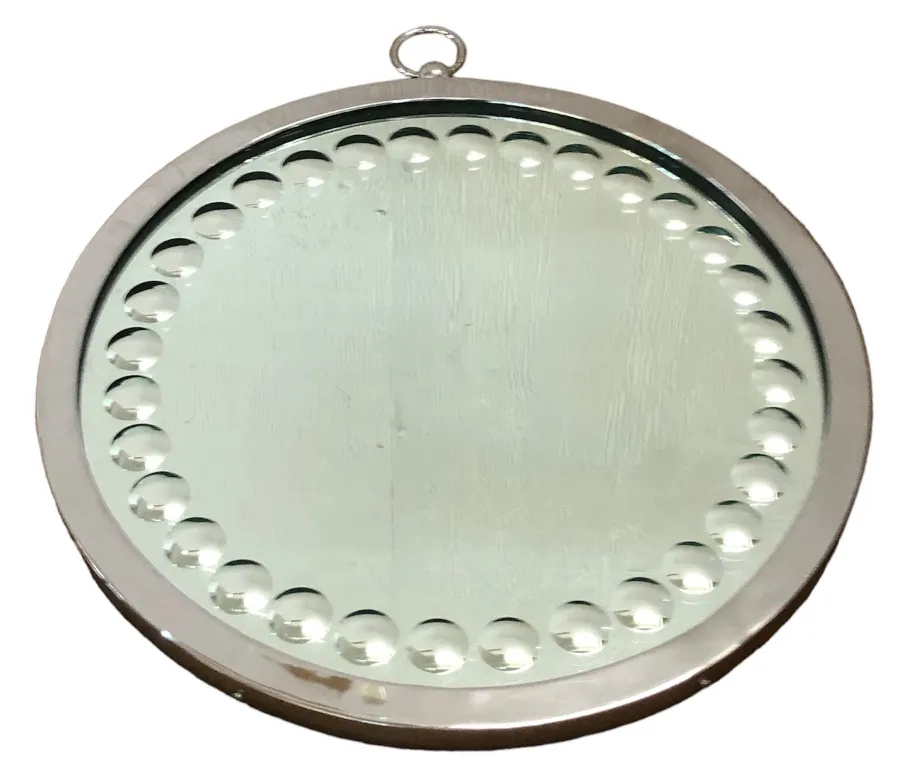 two antique round mirrors in a decorated frame