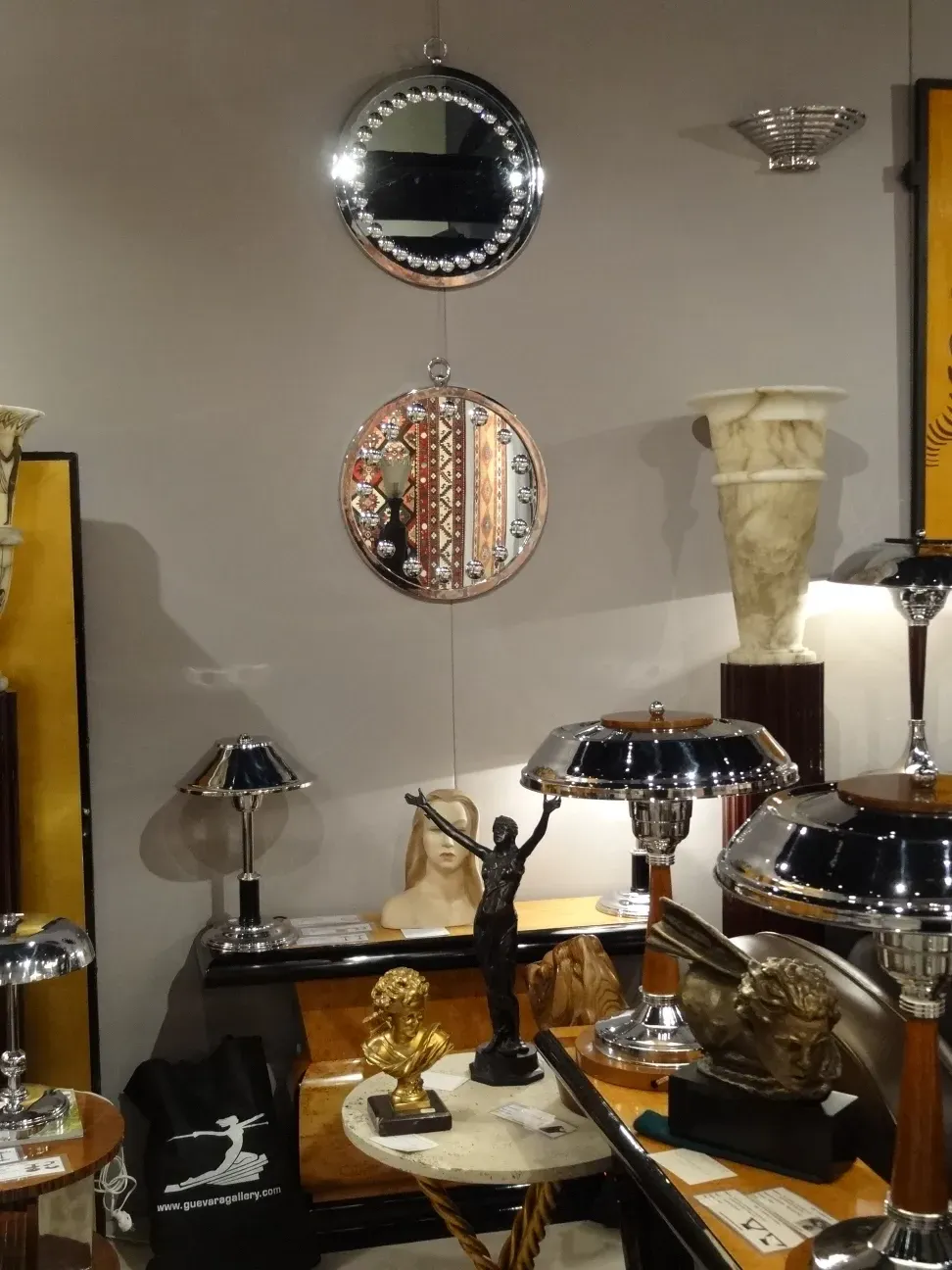 two round mirrors in an antique display.