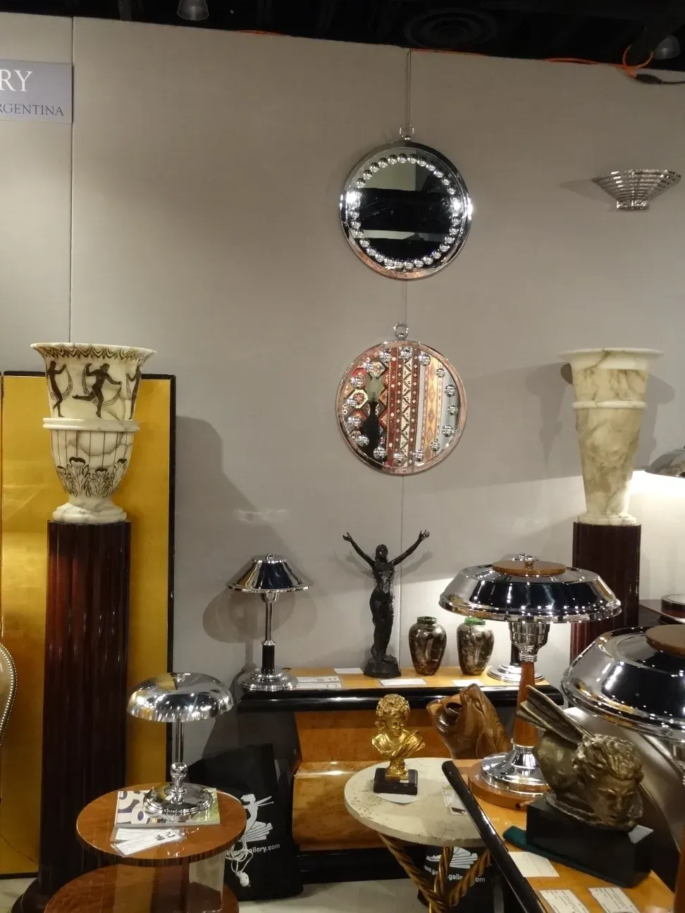two decorative antique mirrors in an exhibition with decorative elements