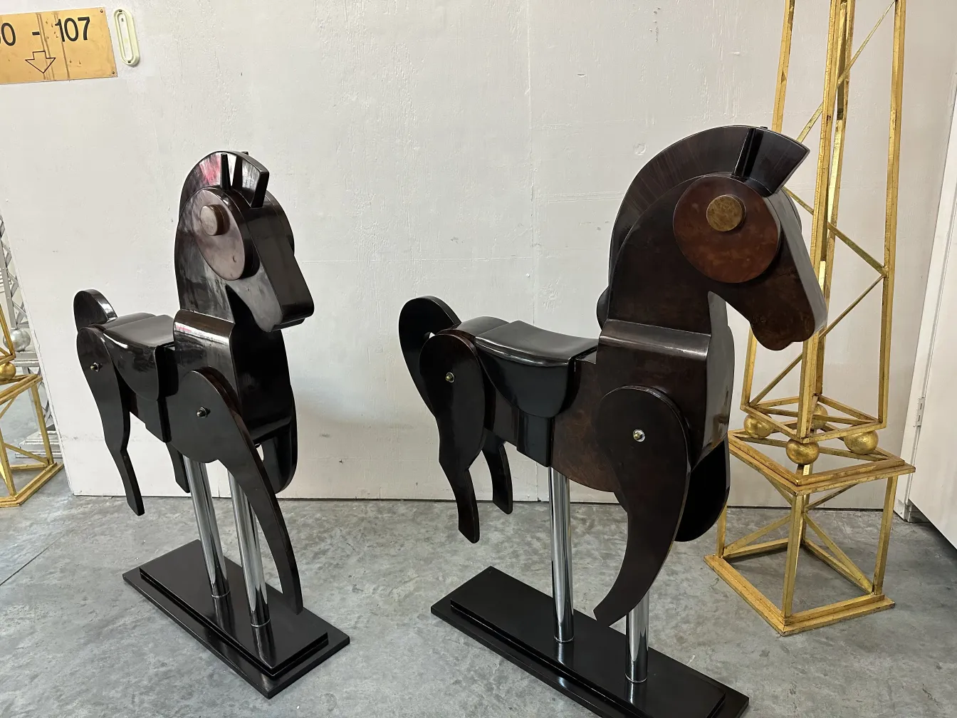 Antique decorative piece featuring two horses in an elegant setting.