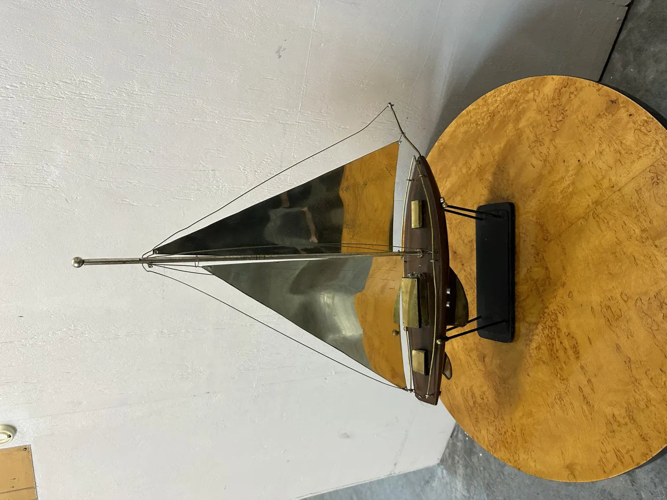 antique designer's ship model with shiny sails in a classy setting