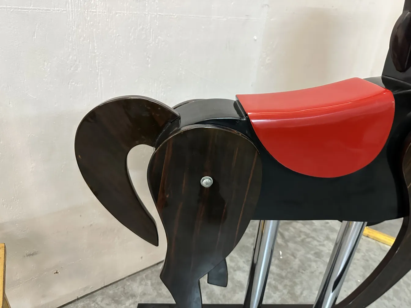 Antique horse sculpture with decorative details, neutral background.