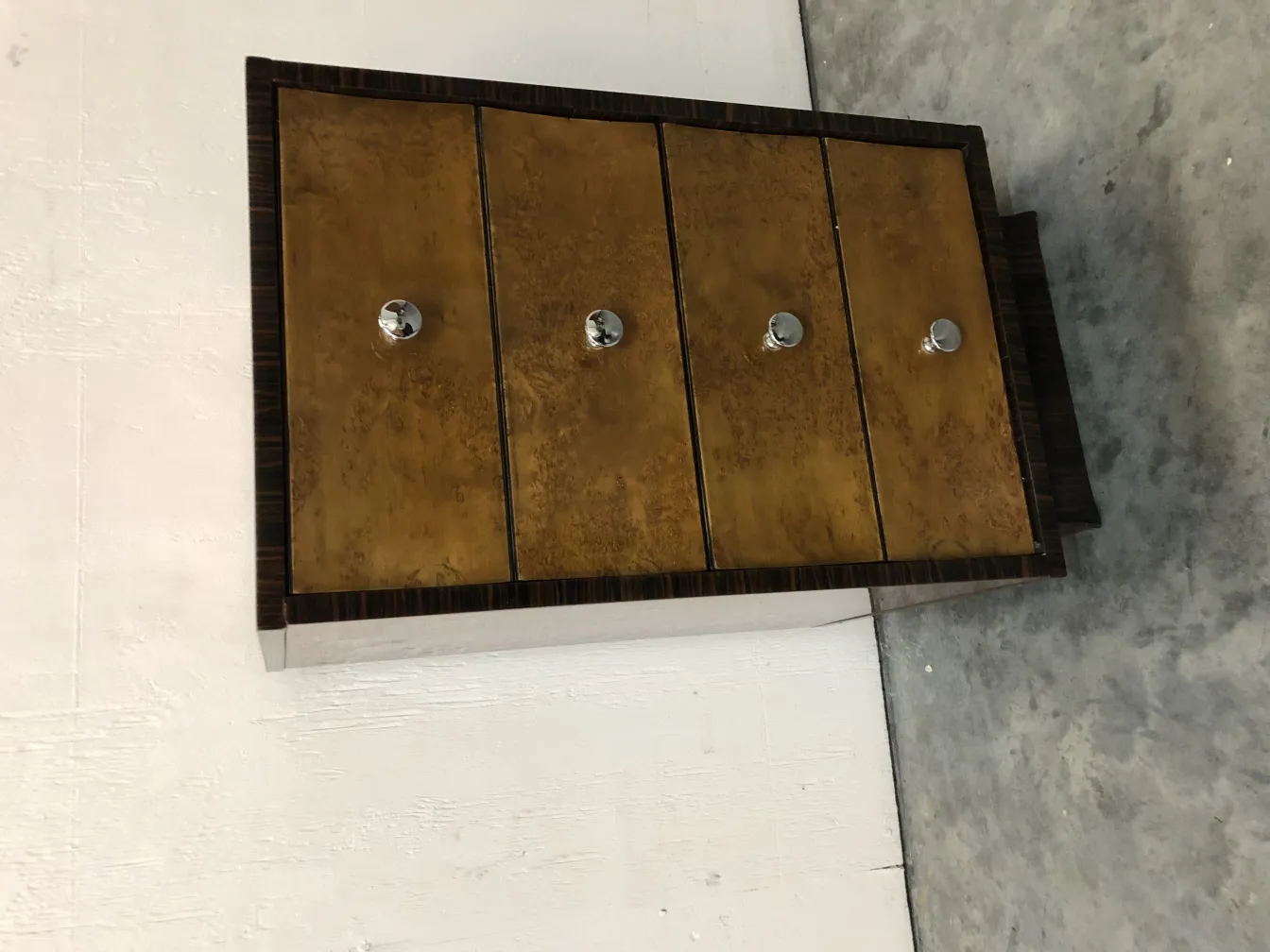 Antique cabinet with four drawers in a modern setting.