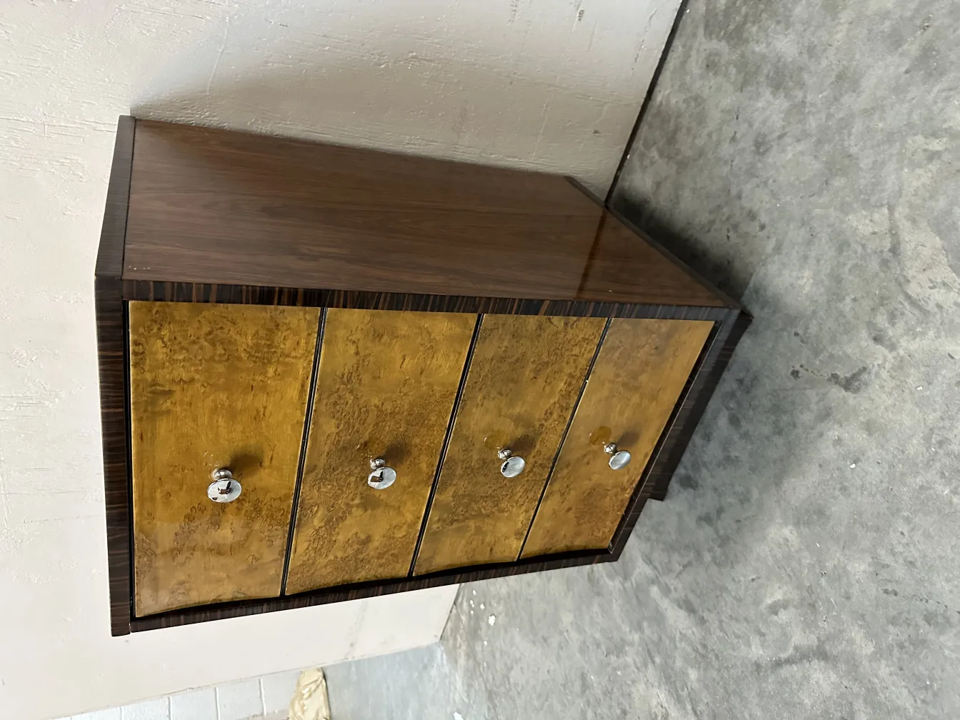 Antique cabinet with four drawers, decorative finishes, indoor setting