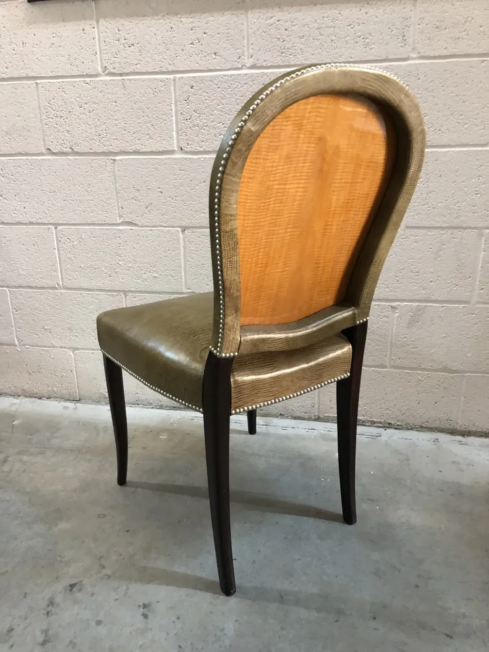 Side view of 12 antique chairs featuring an elegant gold finish