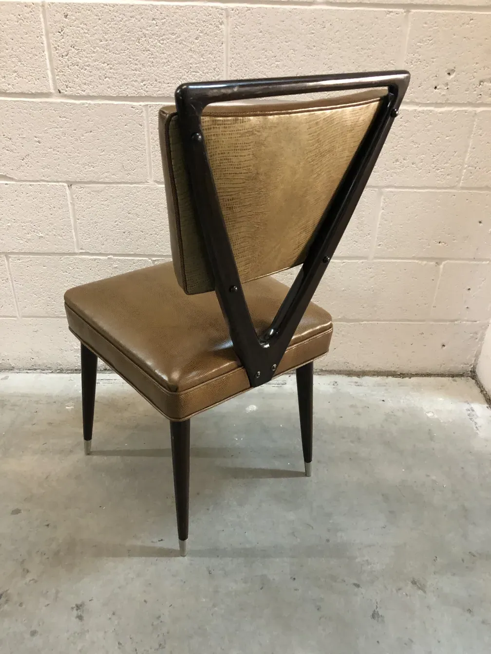 Side view of 12 chairs carlo mollino with distinctive backrest