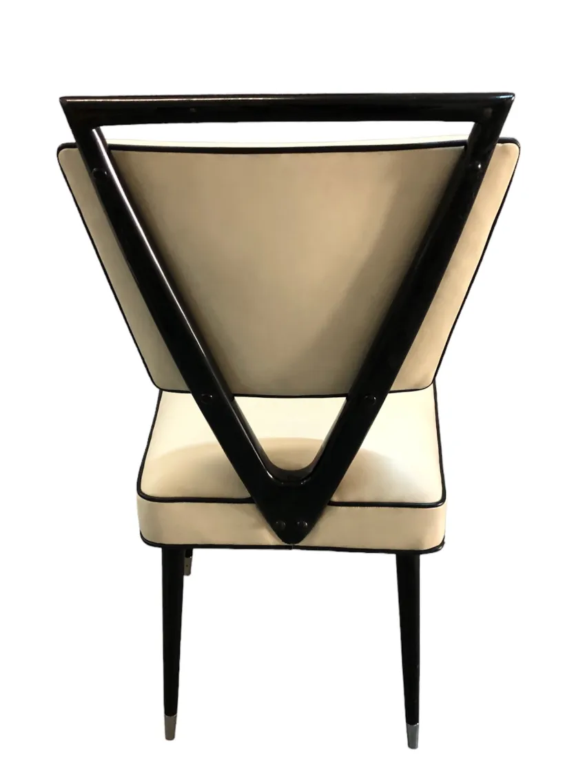 Rear view of 2 antique chairs featuring a triangular design.