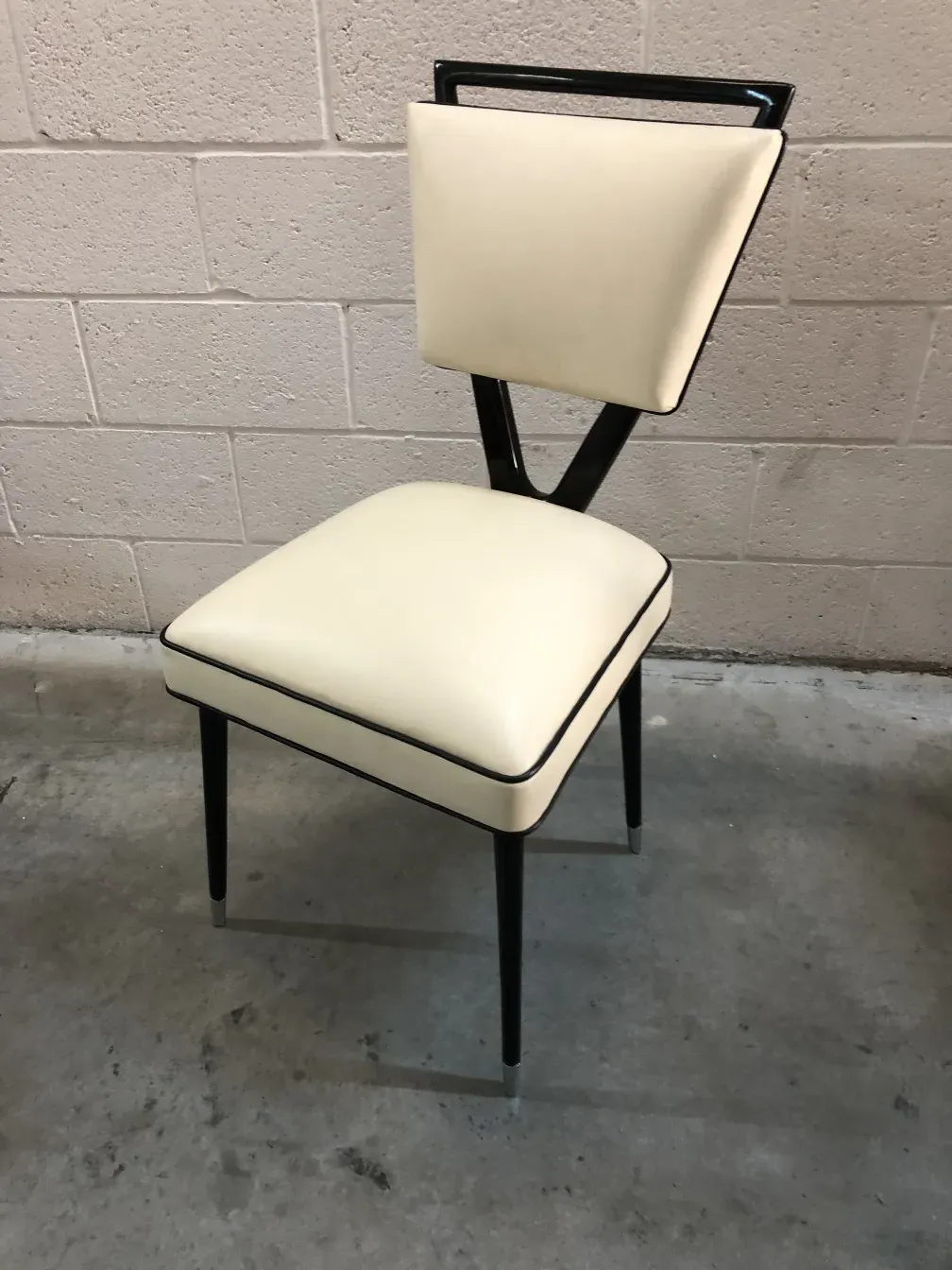 Detailed view of 2 antique chairs carlo mollino in a simple setting