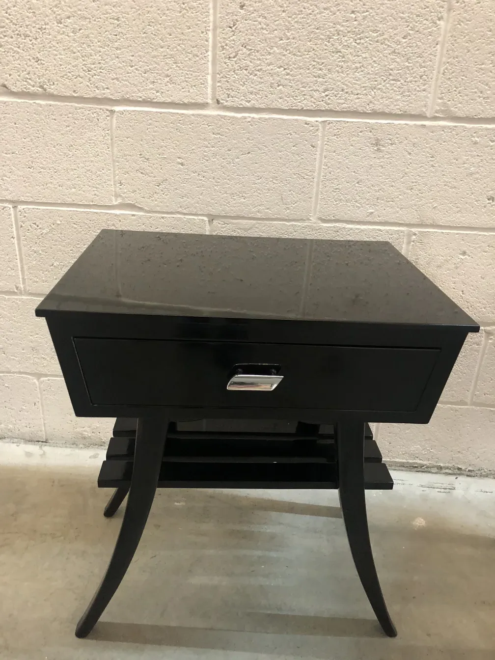 antique black bedside table with a drawer and curved legs