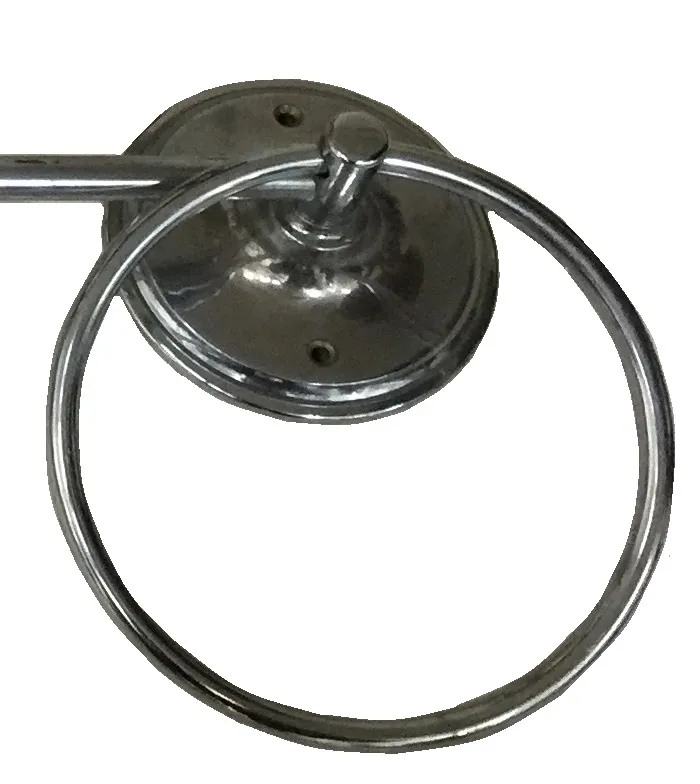 Three antique towel racks with decorative details in a bathroom.