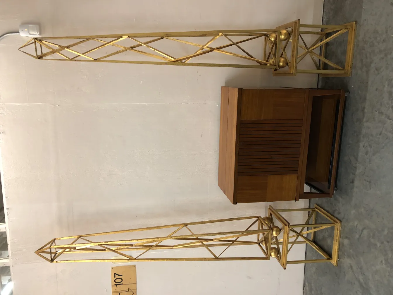 Two antique decorative obelisks with an elegant design and tall shape.