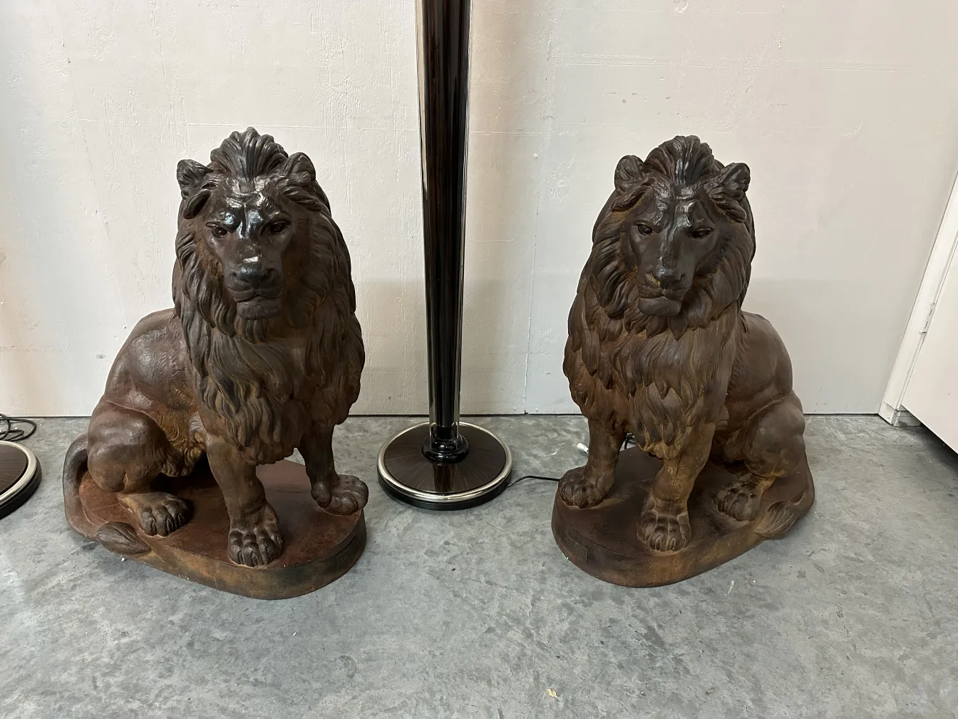 Antique statues of two lions on sculptural base