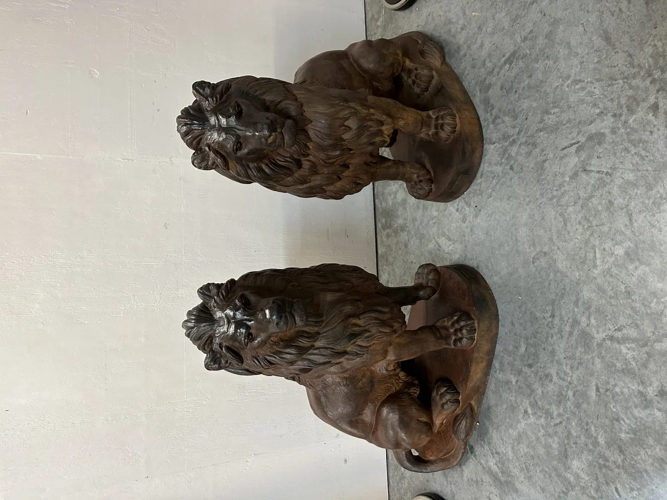 two antique lions with serene details on the base.