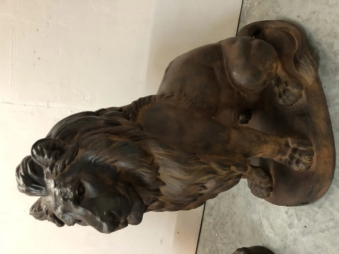 antique sculpture of two lions in majestic posture